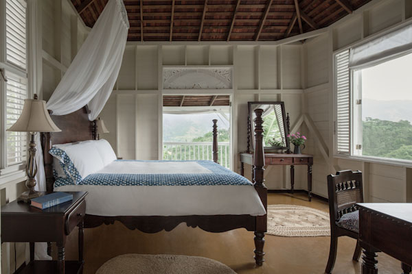 A four-poster bed in a bright timber room at Strawberry Hill