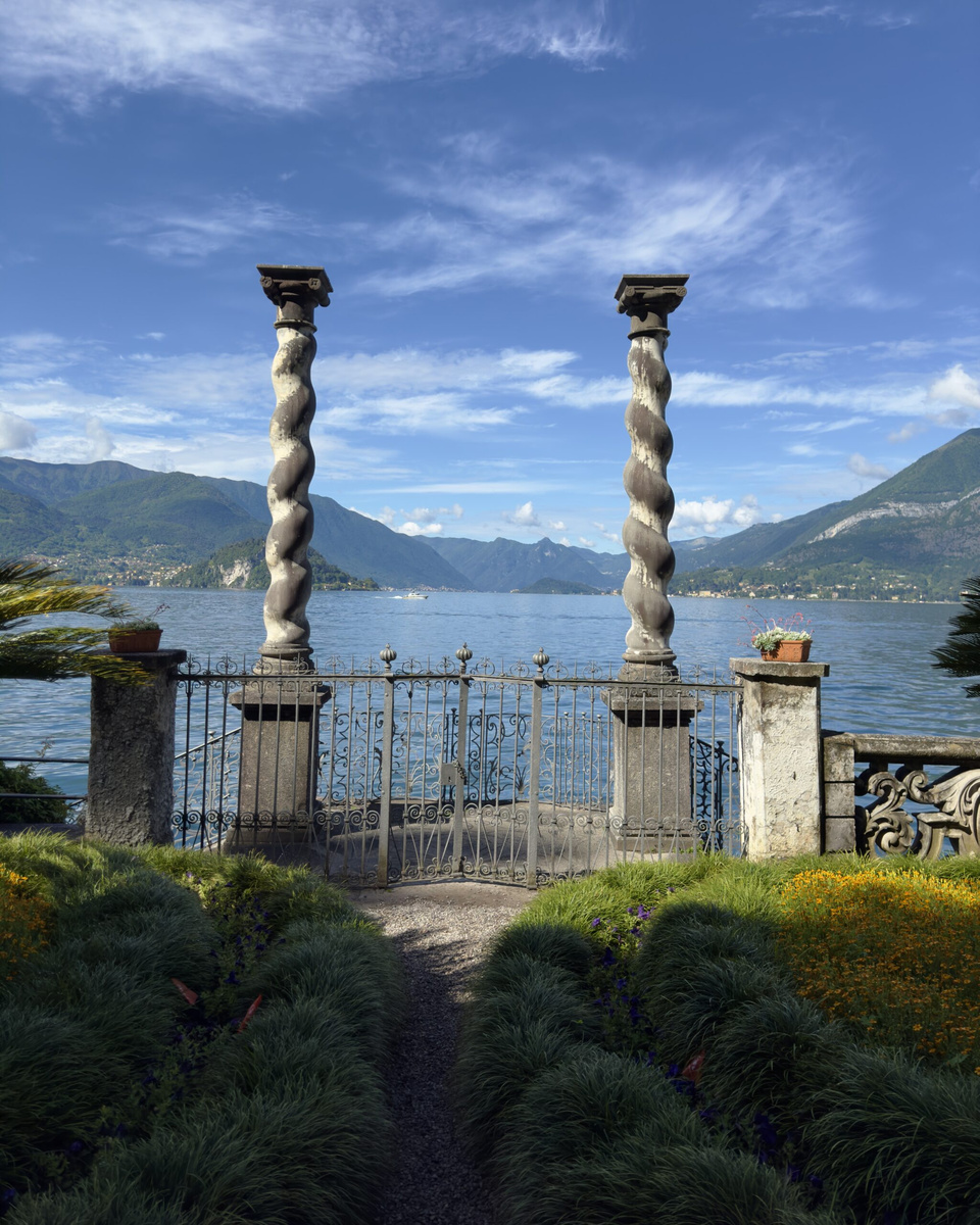Twisted stone columns frame Lake Como and the mountains in the gardens of Villa Monastero.