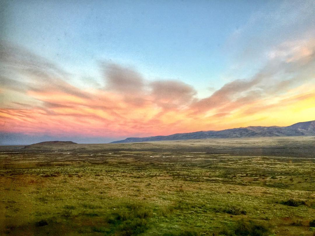 A broad Patagonian steppe beneath a pink and gold sunset near El Calafate.