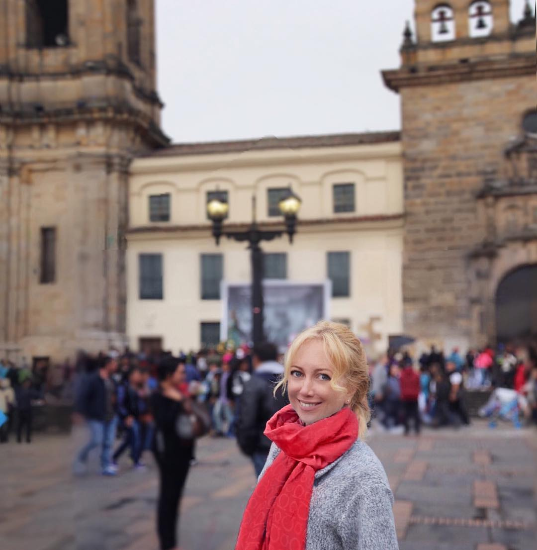 Olga in Bogotá with the cathedral and Plaza de Bolívar behind her.