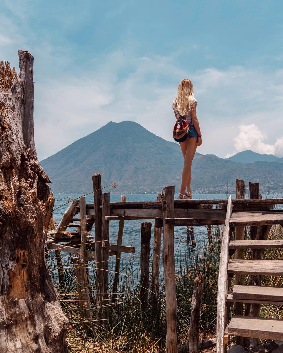 Olga looking across a volcanic Guatemalan landscape from a wooden lookout.