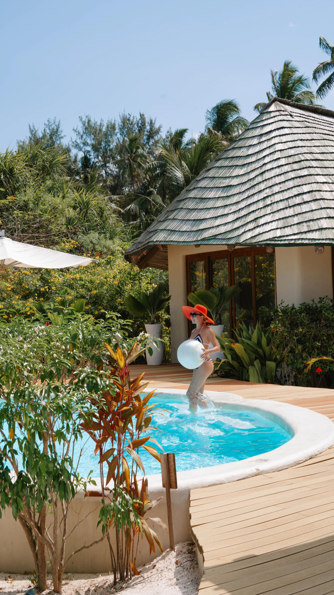 Olga in a small private pool surrounded by tropical gardens in Zanzibar.