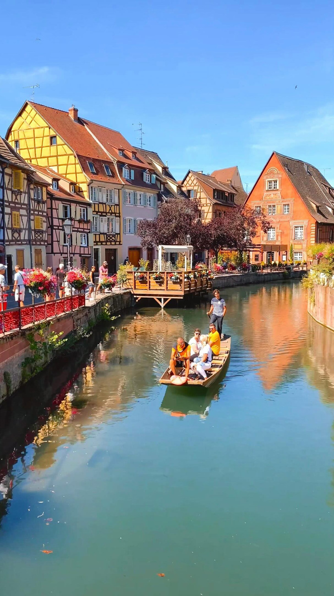 Half-timbered houses and a flower-lined canal in Colmar.