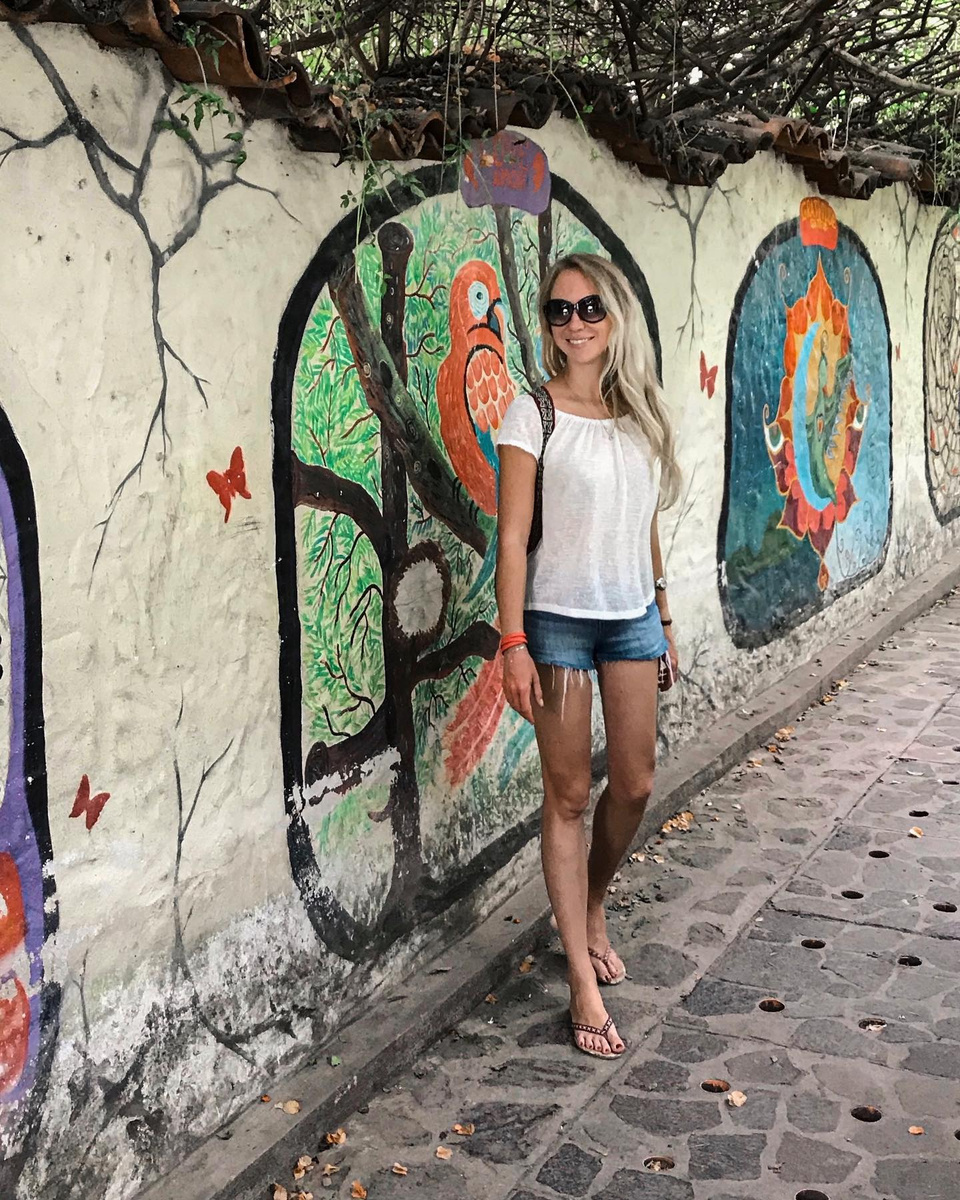 Olga beside a vivid street mural in San Marcos, Guatemala.