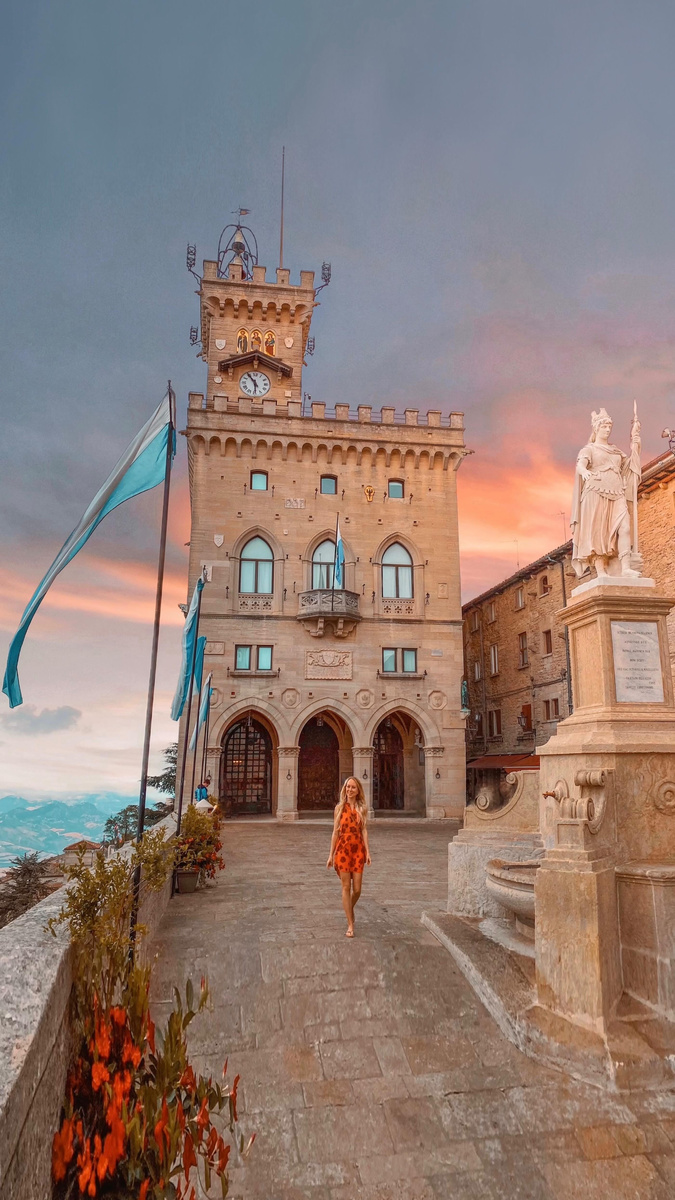 Olga crossing the stone square before Palazzo Pubblico in San Marino.