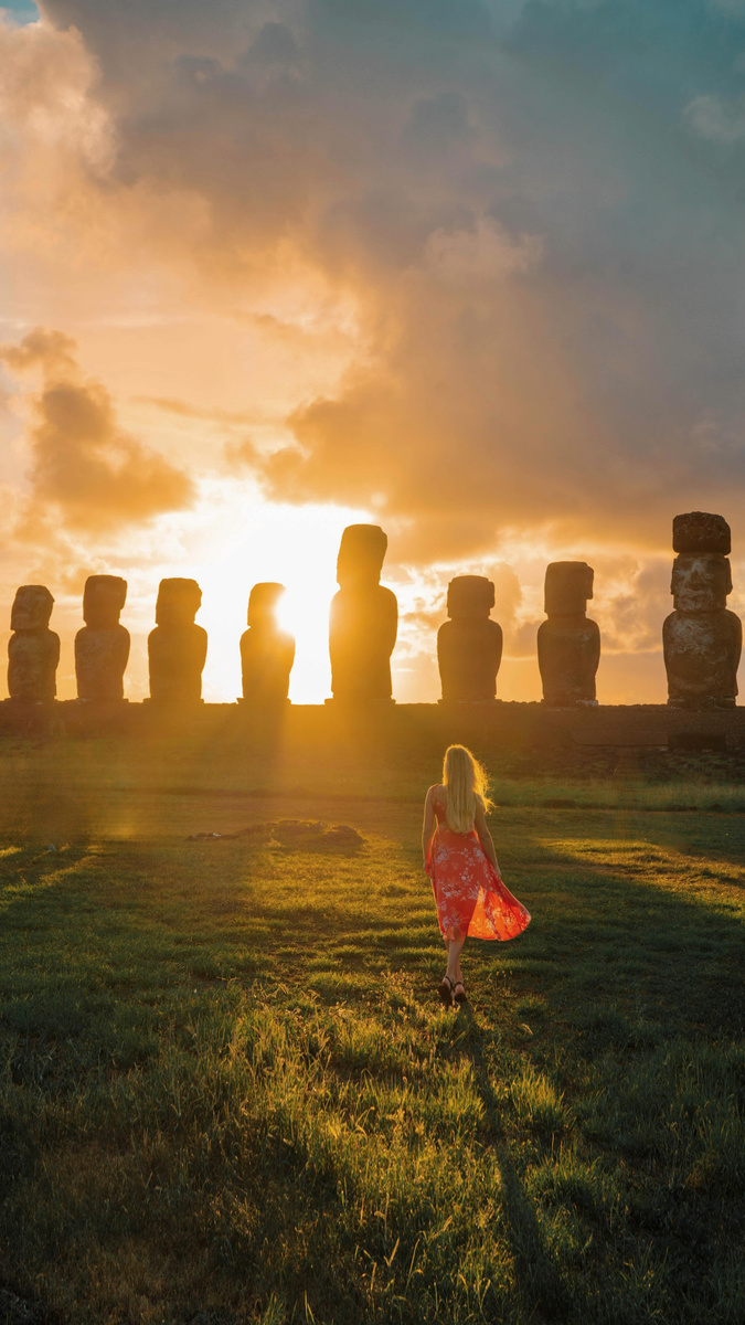 The moai of Ahu Tongariki silhouetted against a golden Easter Island sunrise.