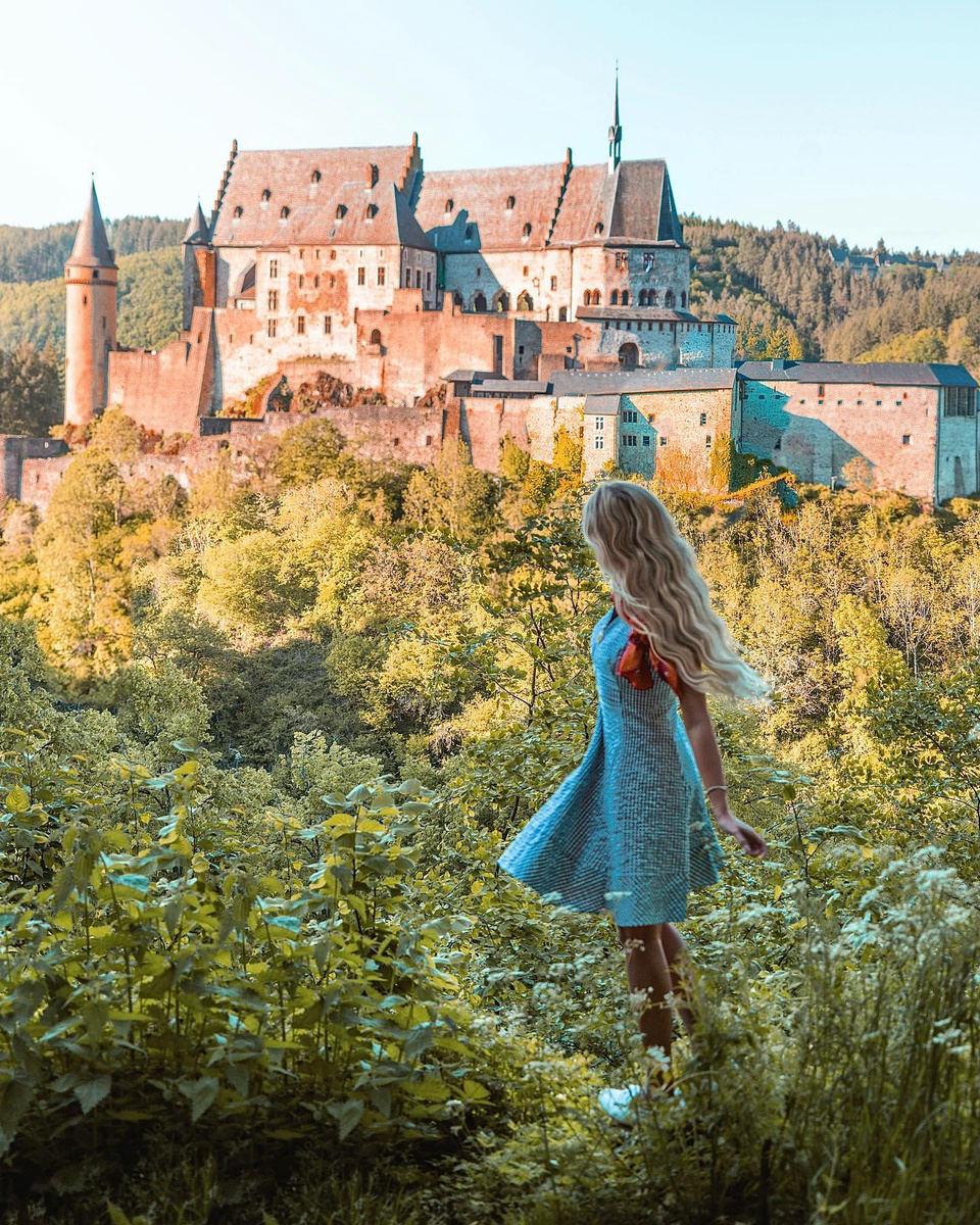Olga looking towards hilltop Vianden Castle in Luxembourg.