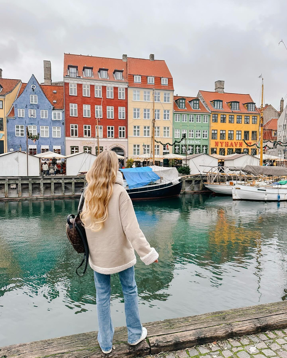 Olga beside the colourful historic houses of Nyhavn in Copenhagen.