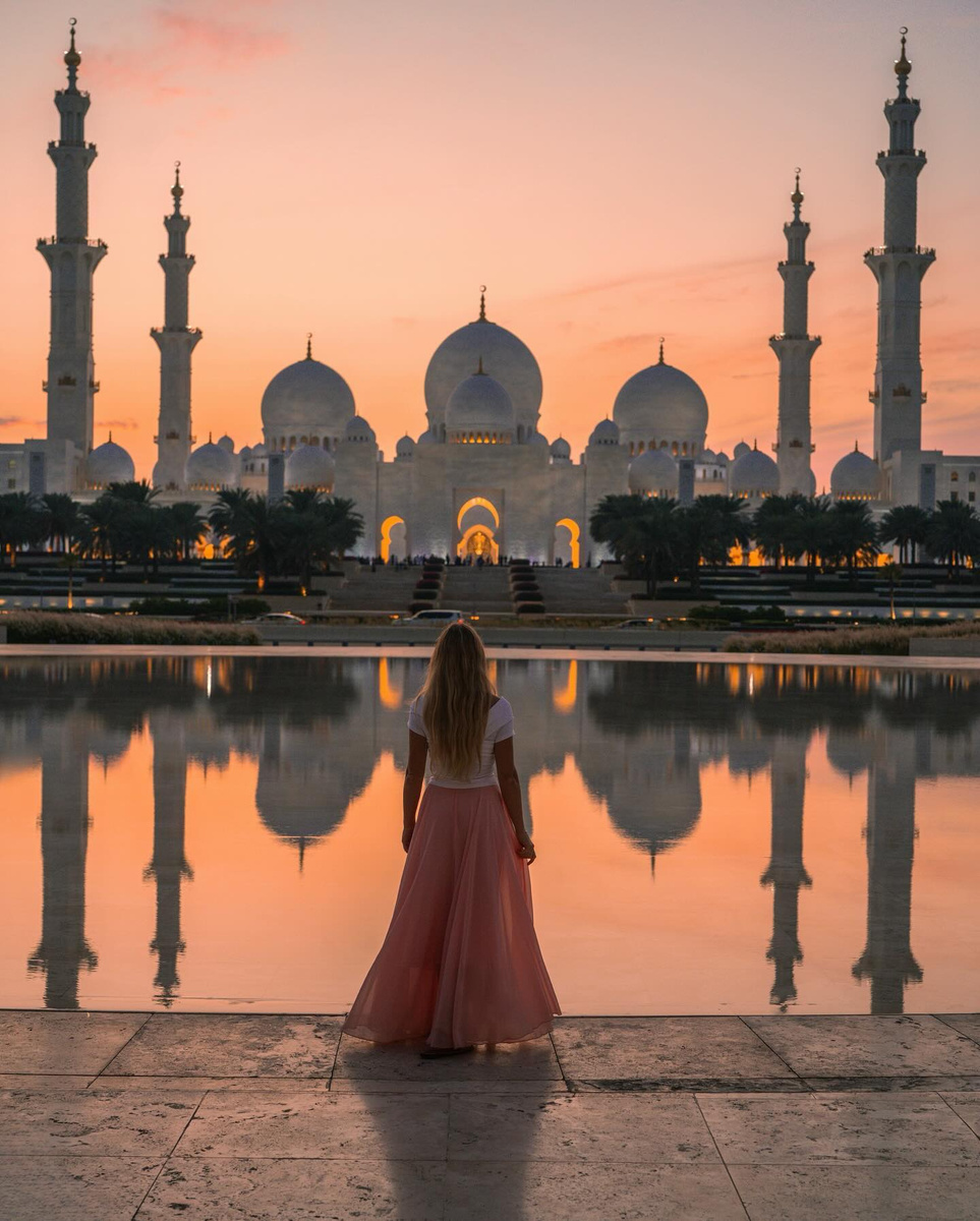 Olga before Sheikh Zayed Grand Mosque in Abu Dhabi at sunset.