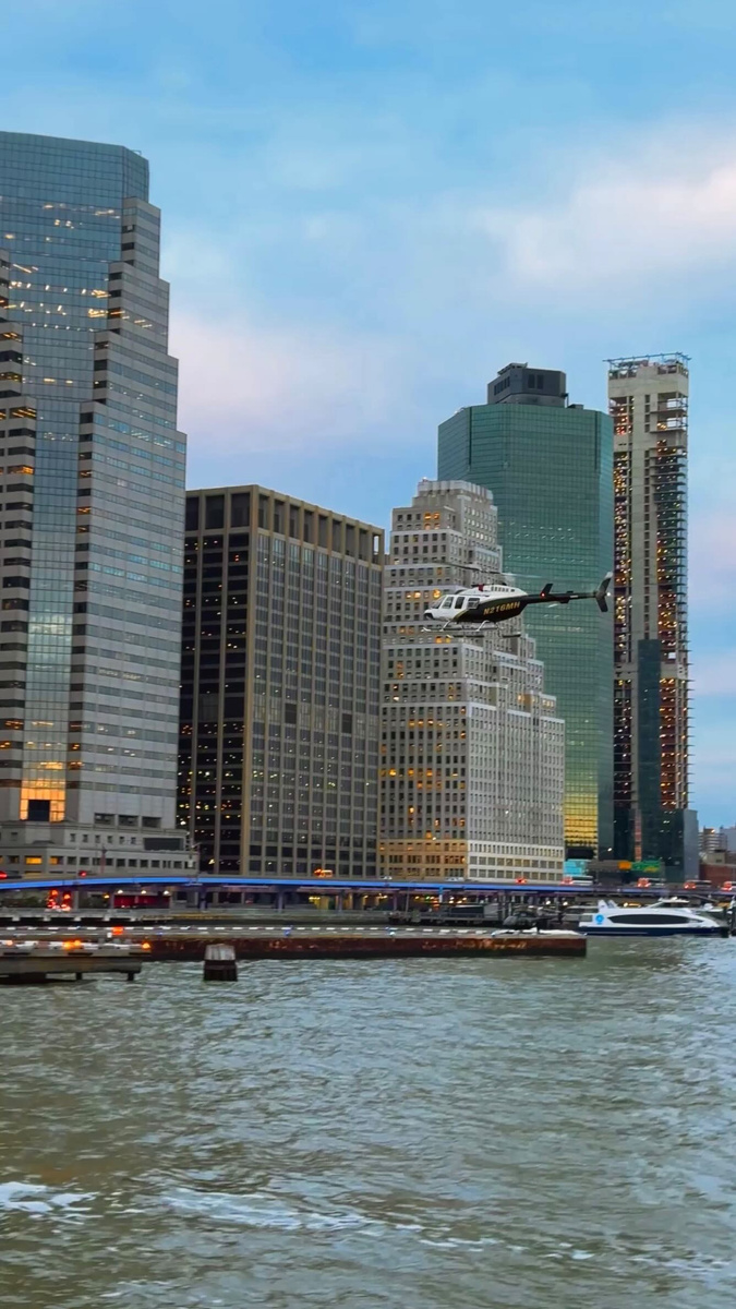 A helicopter passing the skyscrapers of Lower Manhattan.