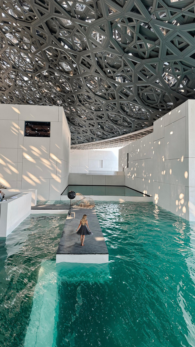 Olga kayaking beneath the patterned dome of Louvre Abu Dhabi.