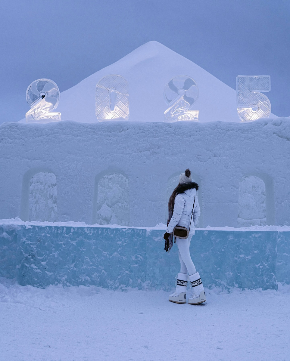 Olga standing within a sculptural installation of snow and ice in Rovaniemi.