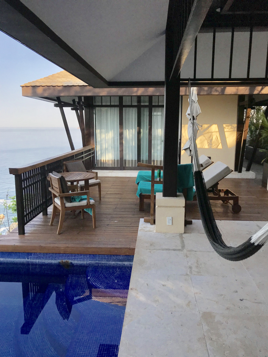 A hammock, loungers and a timber table surround a private villa pool above the Pacific at Banyan Tree Cabo Marqués.