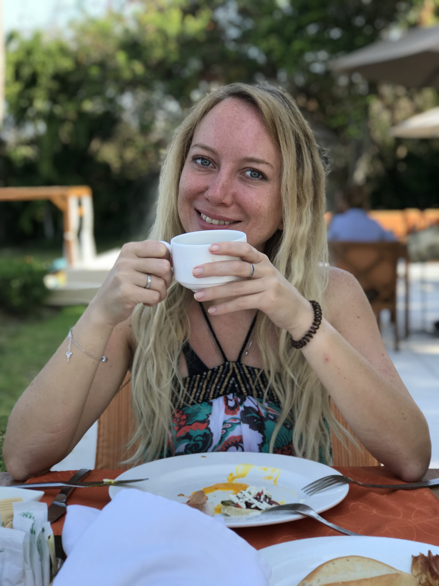 Olga holds a coffee cup at breakfast outdoors at Banyan Tree Cabo Marqués.