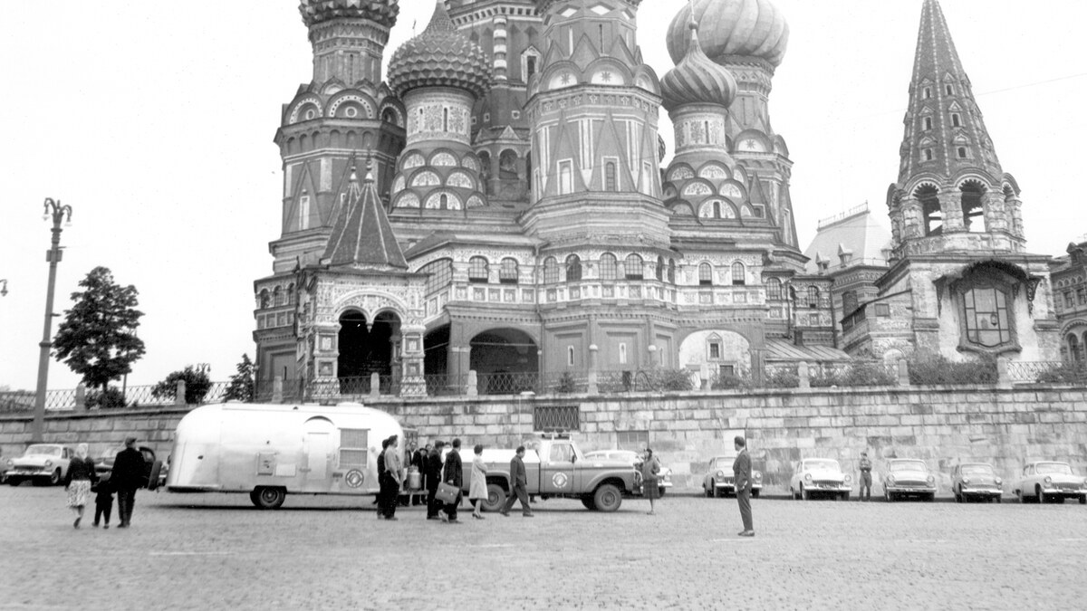 Airstream trailers and period cars parked near St Basil’s Cathedral and the Kremlin during the Around the World Caravan.