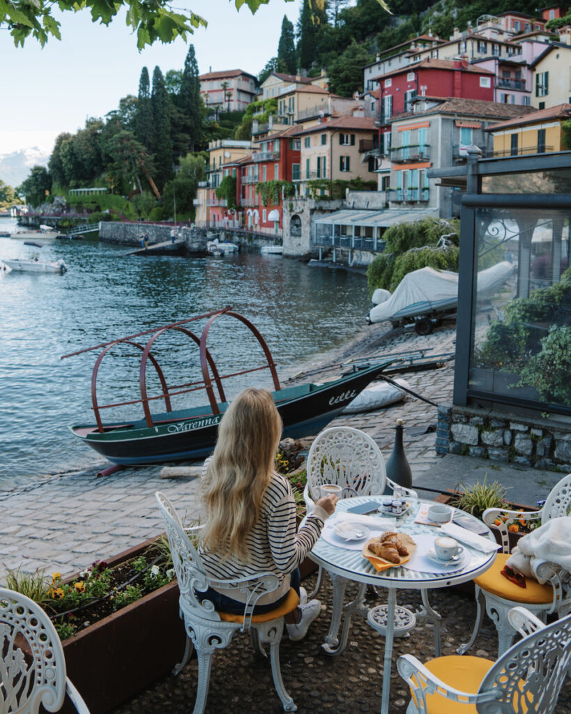 Olga has breakfast at a waterfront table at Bar Il Molo in Varenna.