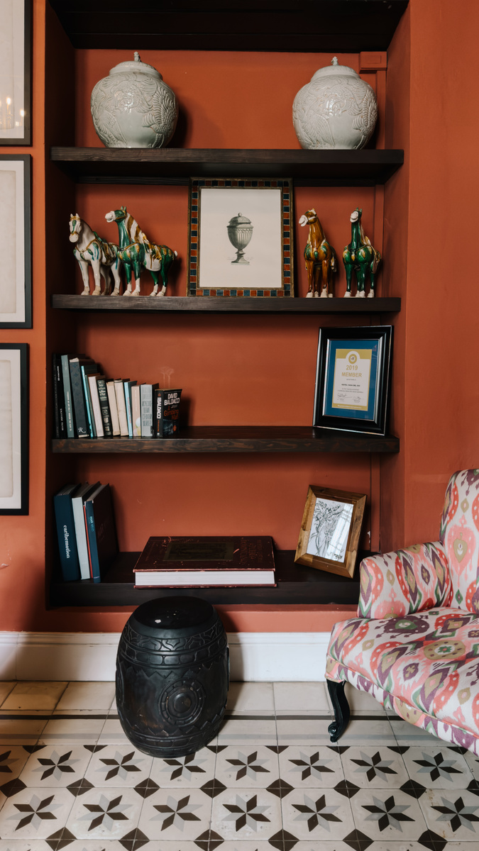 Caribbean art, ceramics, books and carved horse figures fill shelves at Casa del Pozo in Santo Domingo.
