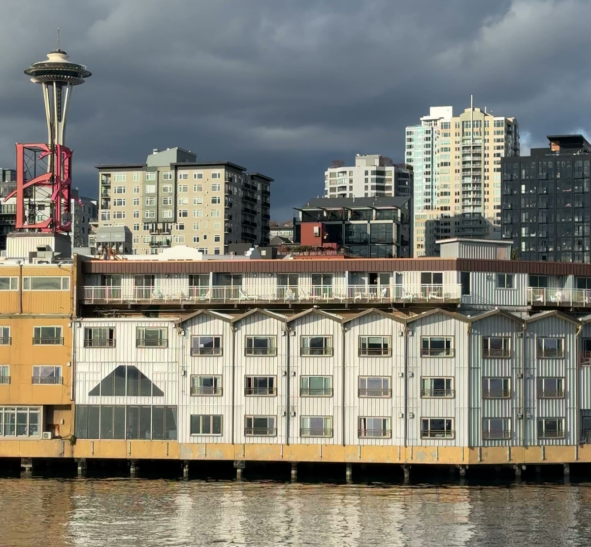 The Edgewater Hotel stands on pilings above Elliott Bay, with its red E sign and the Space Needle behind.