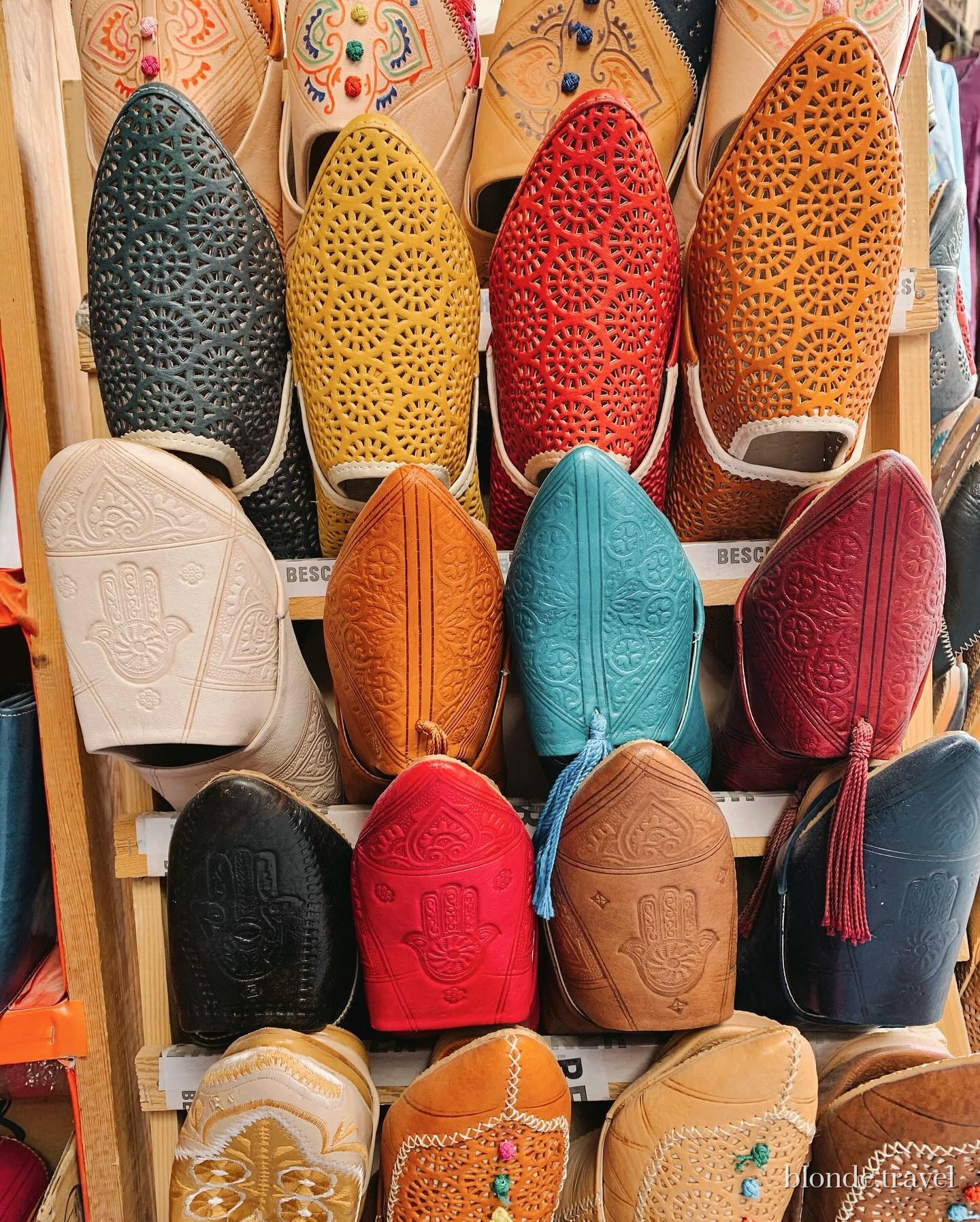 Rows of colorful leather babouche slippers displayed in the Fez medina.