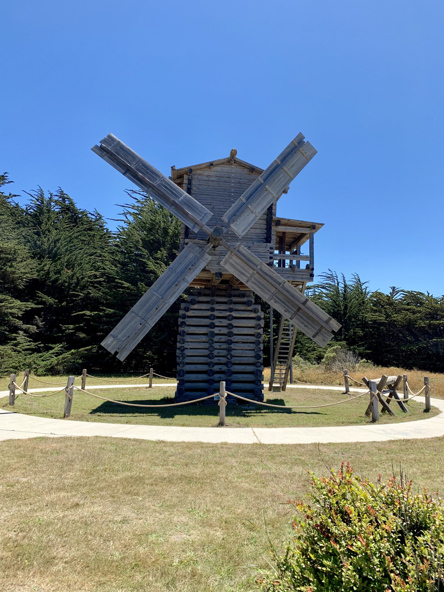 Reconstructed wooden windmill beneath a blue sky at Fort Ross State Historic Park