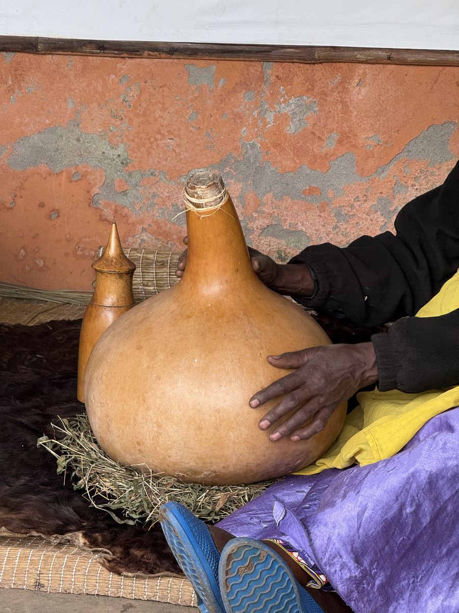 A large dried gourd is held during a demonstration at Gorilla Guardians Village.