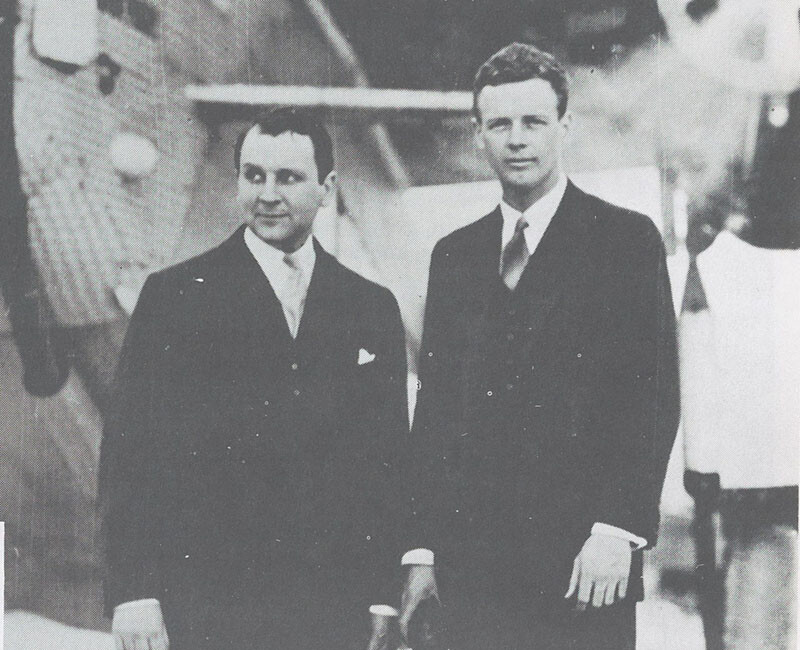 Juan Trippe and Charles Lindbergh stand together in front of a Pan American Airways aircraft at Pan American Field in Miami in January 1929.