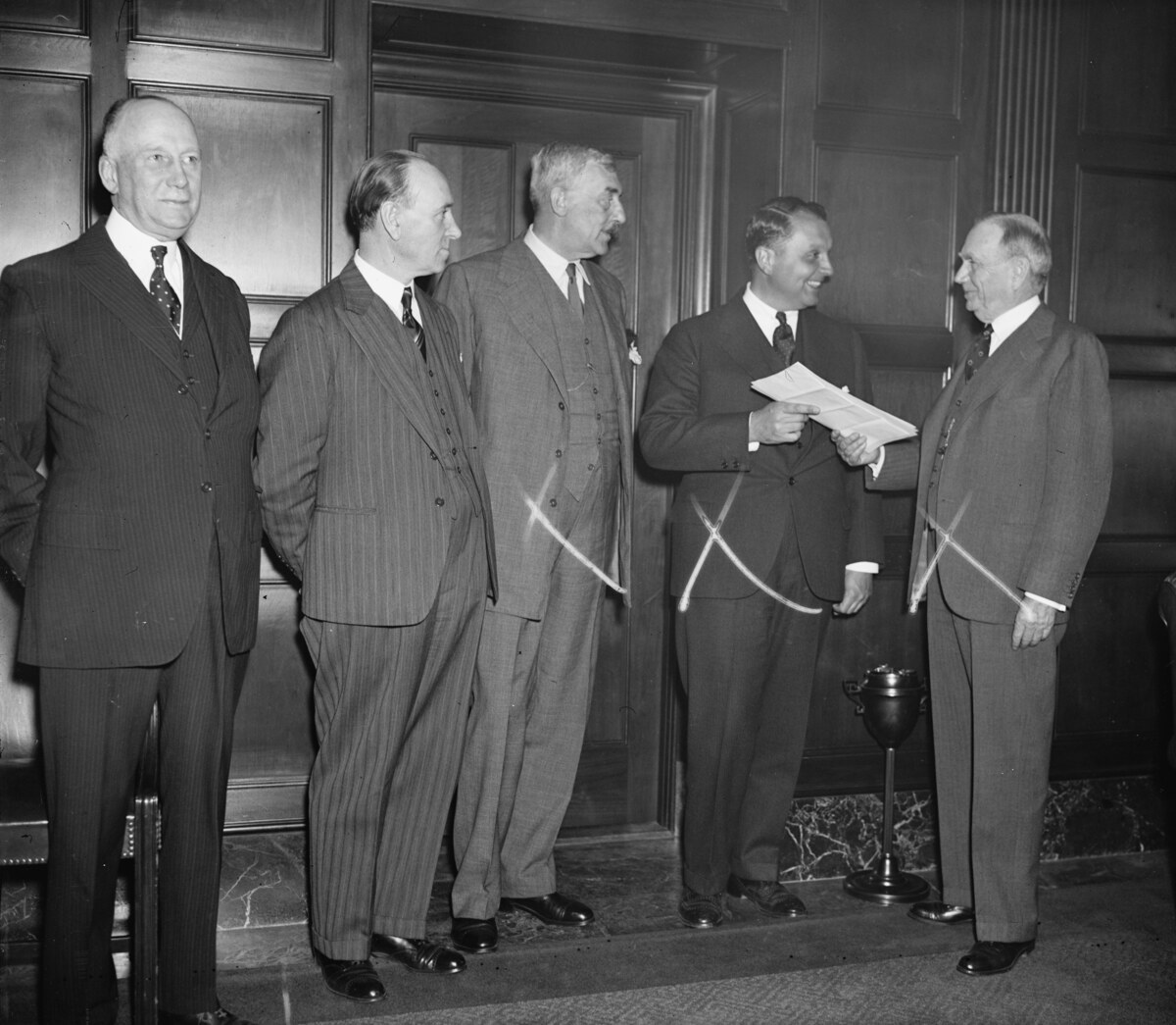 Juan Trippe receives transatlantic air permits from U.S. Commerce Secretary Daniel Roper beside British, Canadian and Irish representatives in 1937.