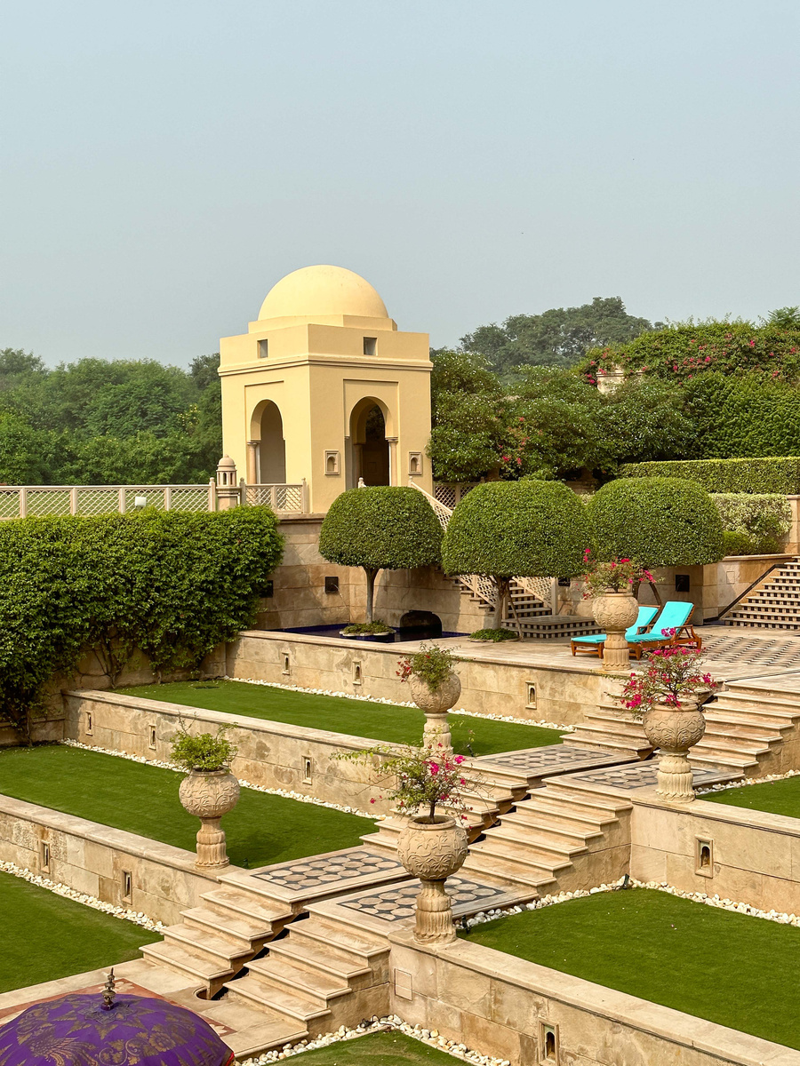 A domed garden pavilion, clipped trees and stone terraces at The Oberoi Amarvilas in Agra.