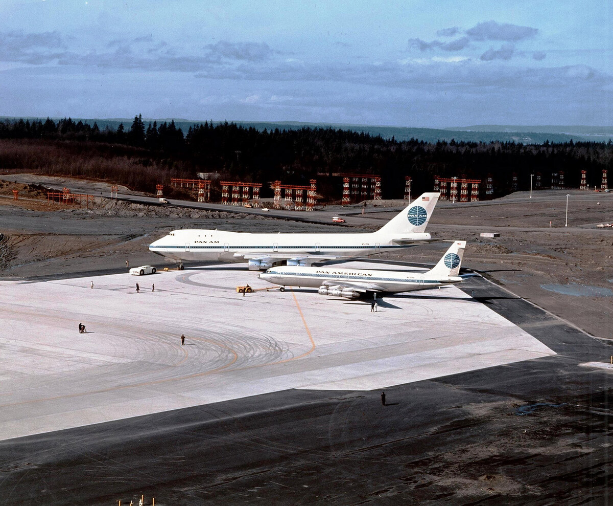 A Pan Am Boeing 747 and Boeing 707 stand together on the apron during the 747 rollout in 1969.