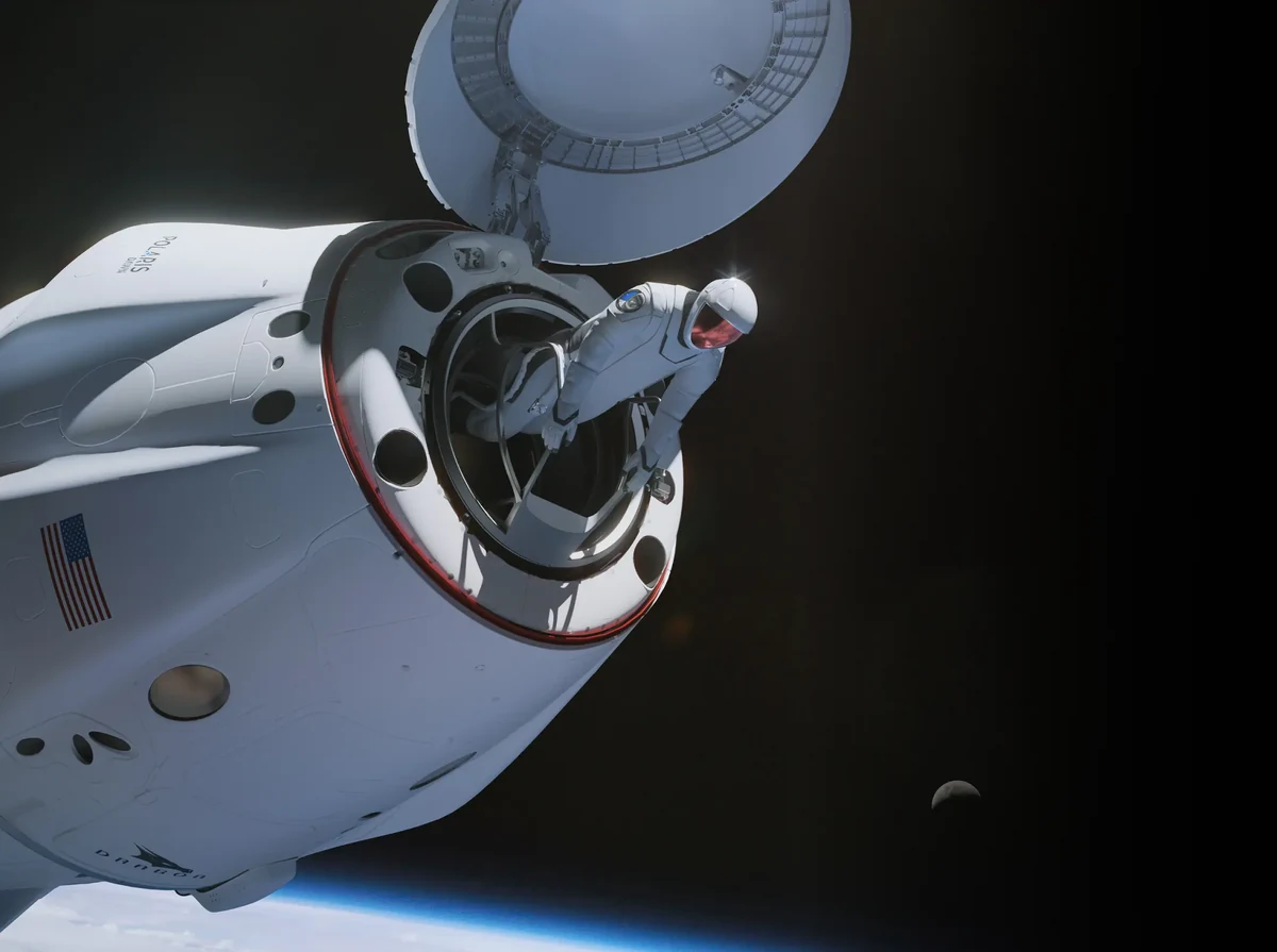 A spacesuited Polaris Dawn crew member leans through the open hatch of a Crew Dragon above Earth.