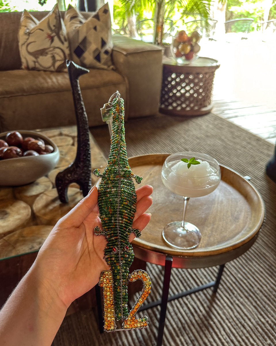 Olga holds a colourful beaded animal ornament in the lounge at Victoria Falls River Lodge.