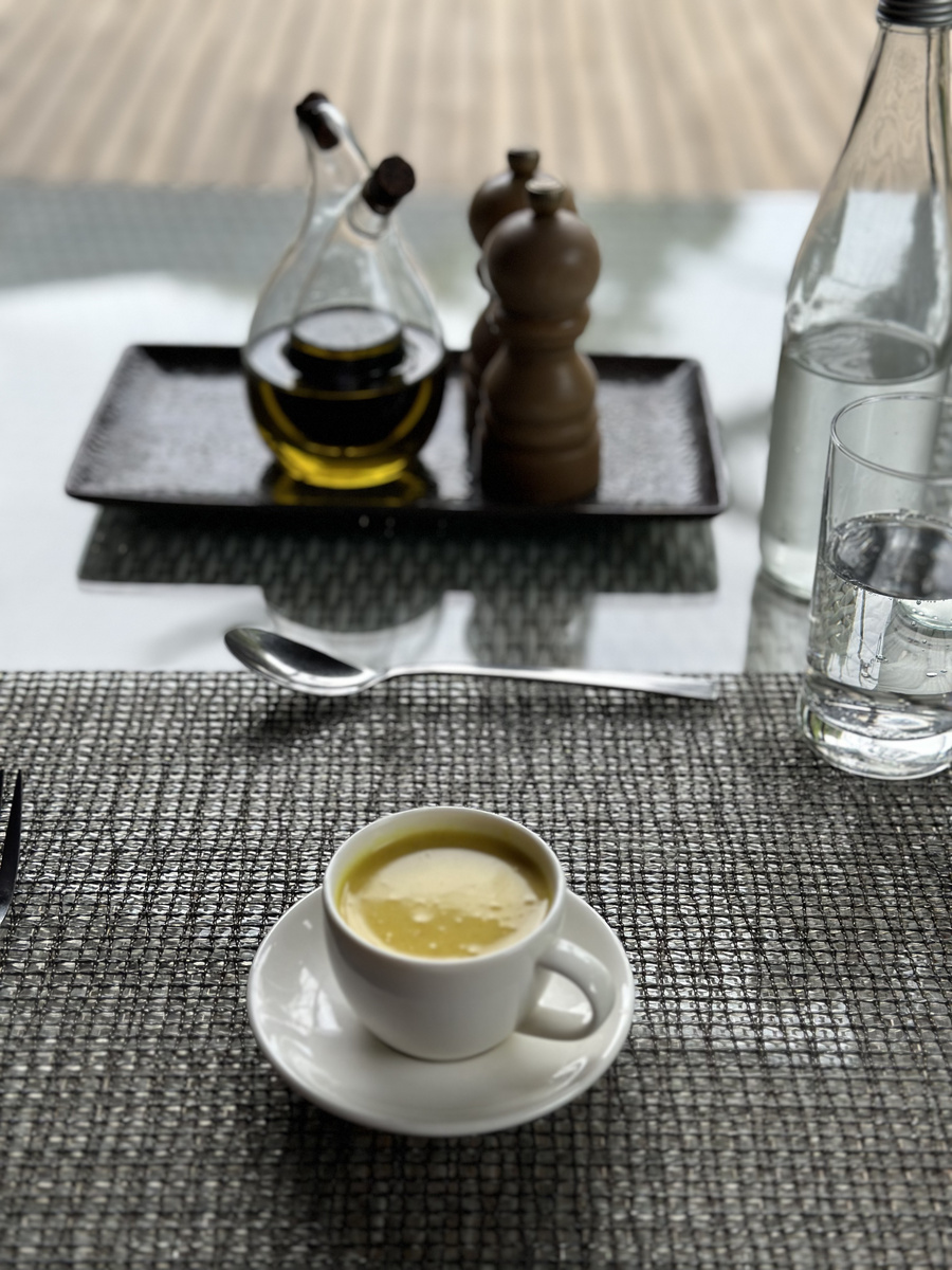 A pale soup is served at a table in Victoria Falls River Lodge.