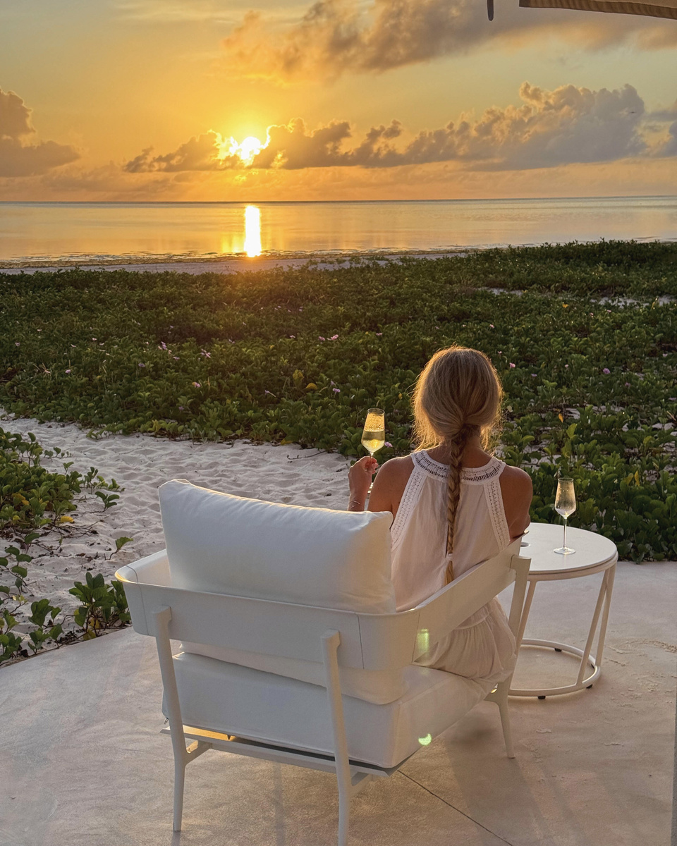 Olga watches the sun rise over the Indian Ocean from a chair at Zanzibar White Sand.