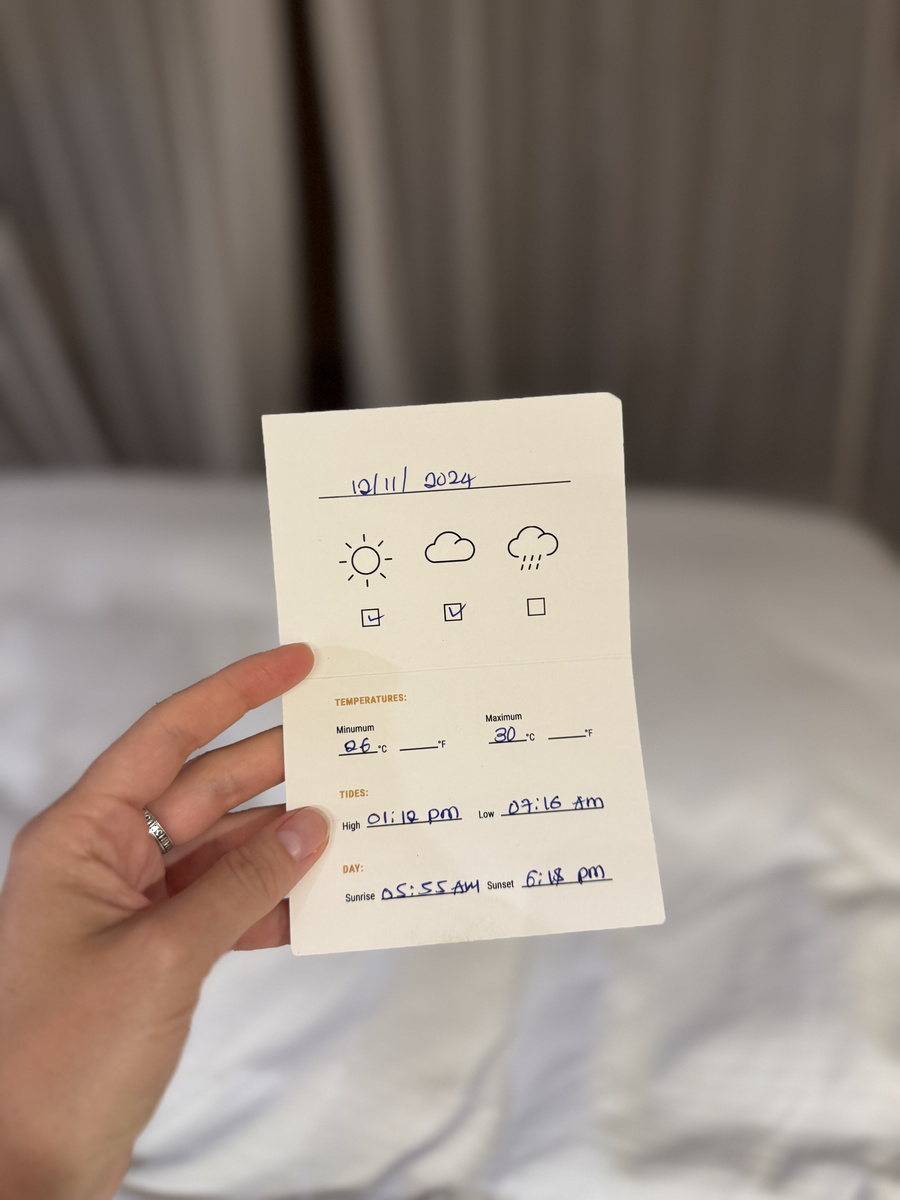 A handwritten card records the next day weather, temperature, tides, sunrise and sunset times.
