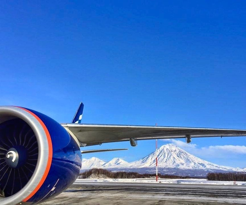 An Aeroflot aircraft on the old Yelizovo airport apron with snow-covered Koryaksky volcano behind