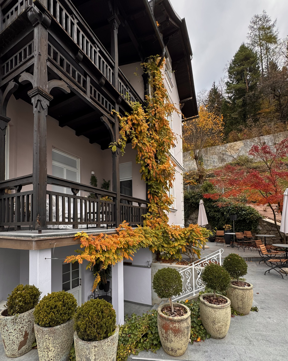 Wooden balconies and autumn vines on the exterior of Villa Adora.