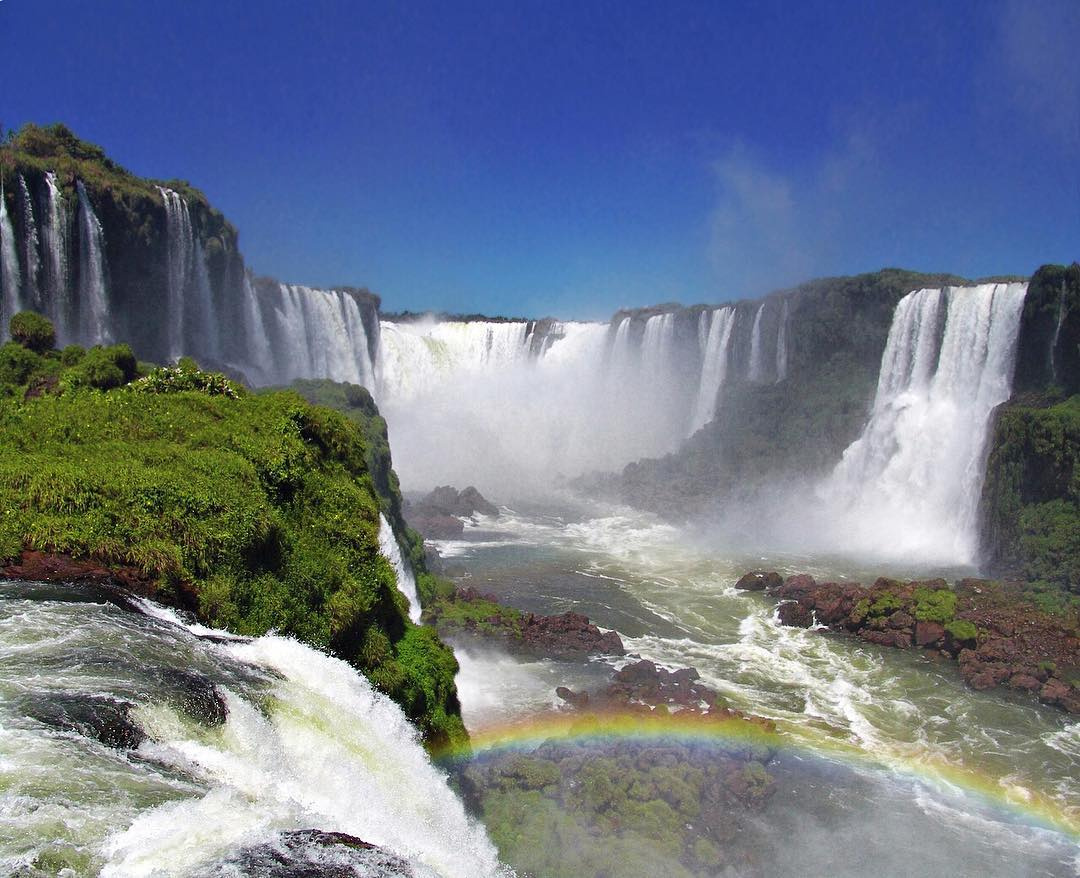 A rainbow forms in the spray of Iguazú Falls, viewed from the Brazilian side.