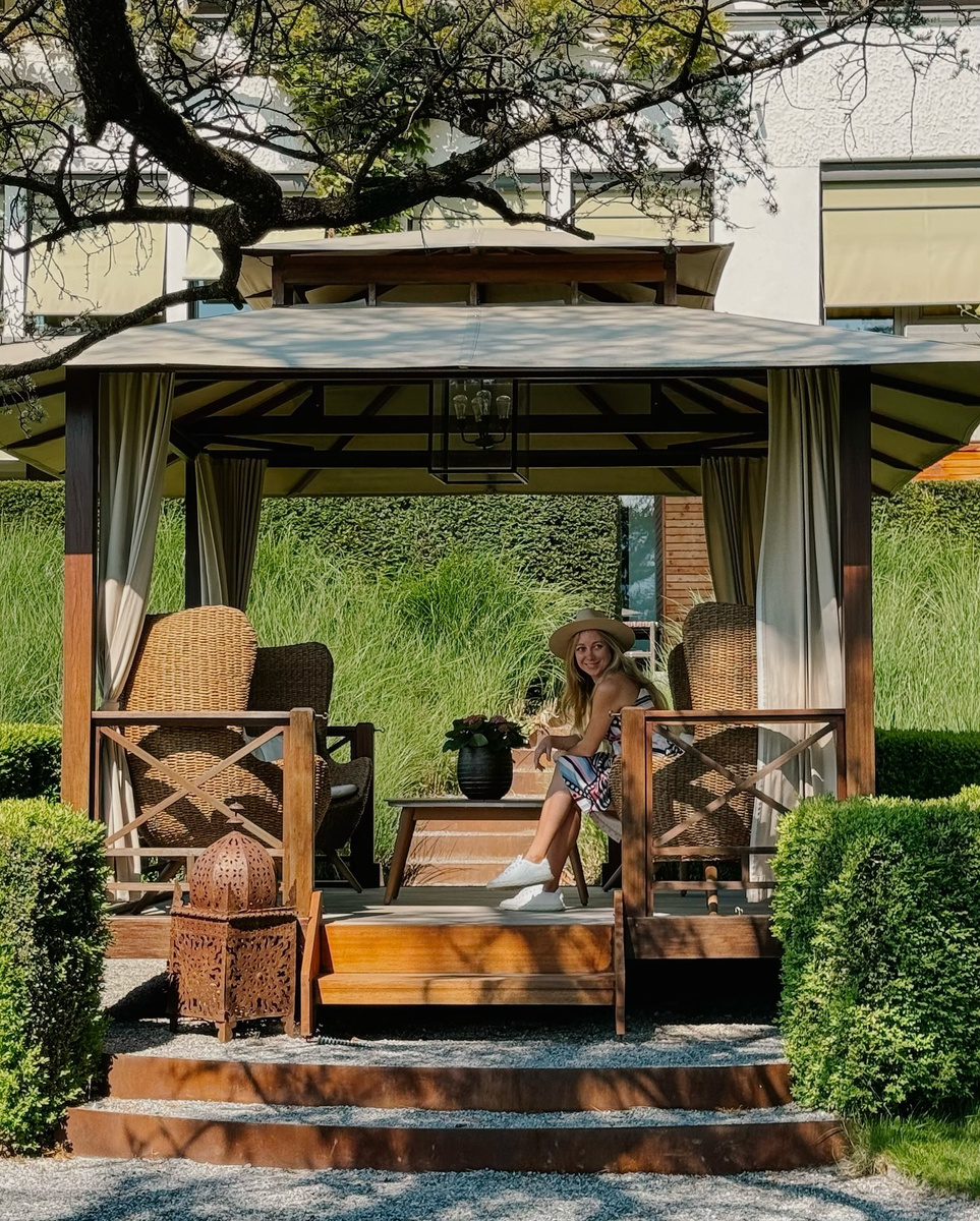 Olga seated in a timber gazebo among the gardens at Park Hotel Sonnenhof.