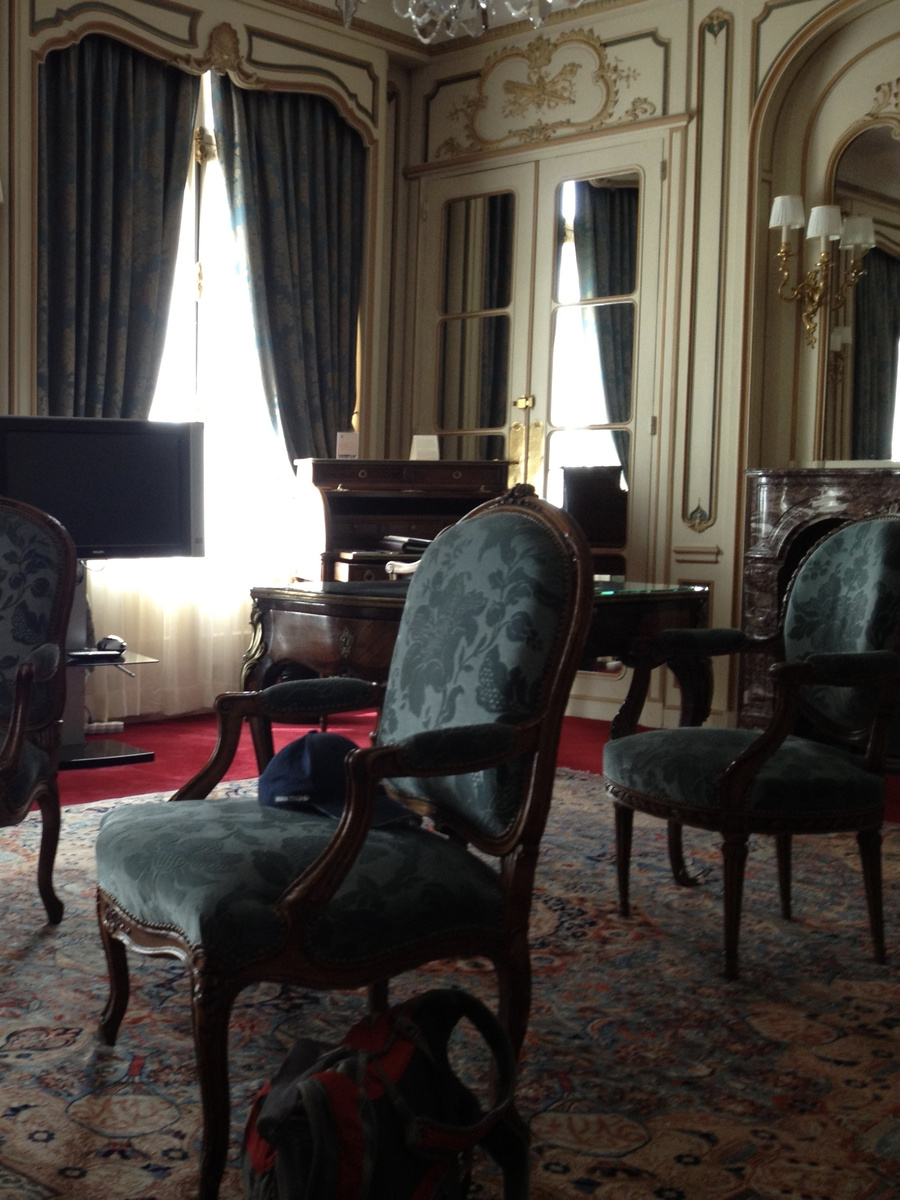 Upholstered chairs, mirrored doors and a writing desk in our room at Hôtel Raphael.
