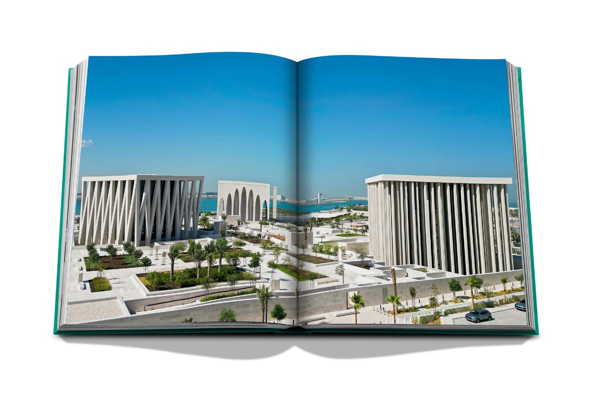 An open spread showing three pale stone buildings and landscaped courtyards beside the sea in Abu Dhabi.