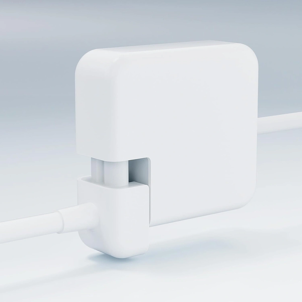 Close-up of the extension cable sliding into the removable-plug fitting on an Apple power adapter.