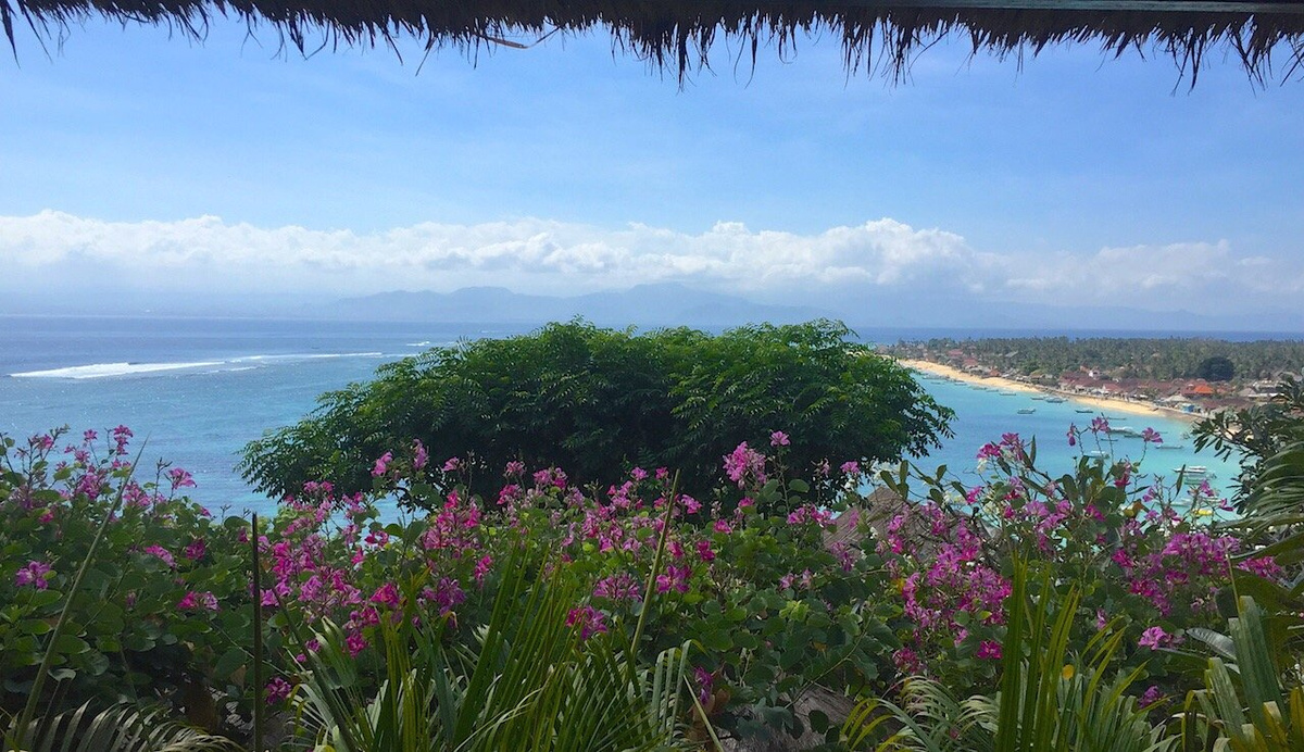 View from a Batu Karang villa over flowering gardens and Jungutbatu Bay towards Bali.