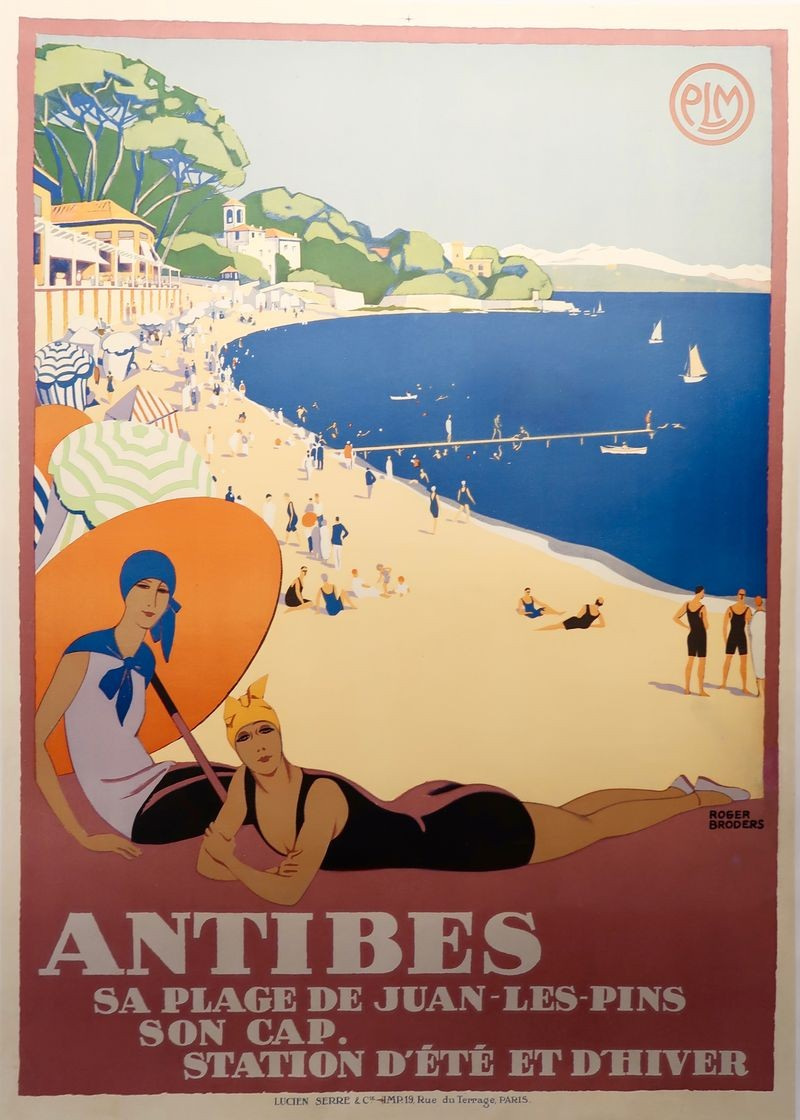 Roger Broders’s colour poster shows women in bathing costumes above a crowded beach and blue bay at Antibes.