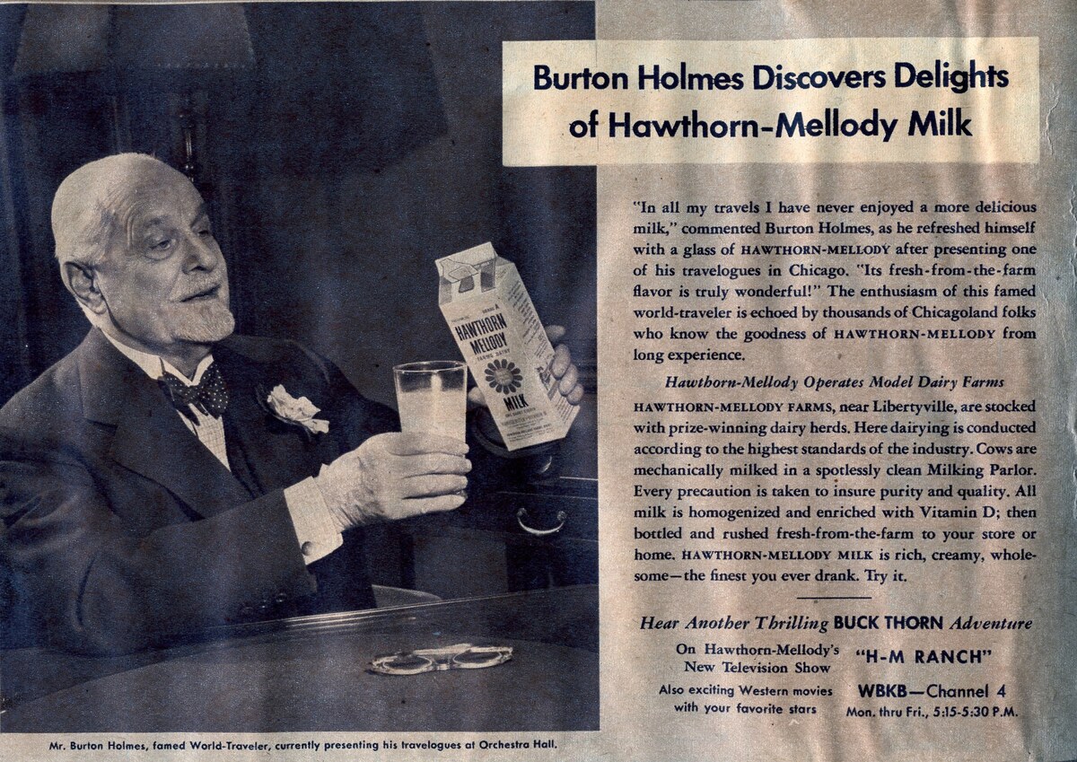 A newspaper advertisement showing an elderly Burton Holmes holding a glass of milk and a carton, with the headline Burton Holmes Discovers Delights of Hawthorn-Mellody Milk.