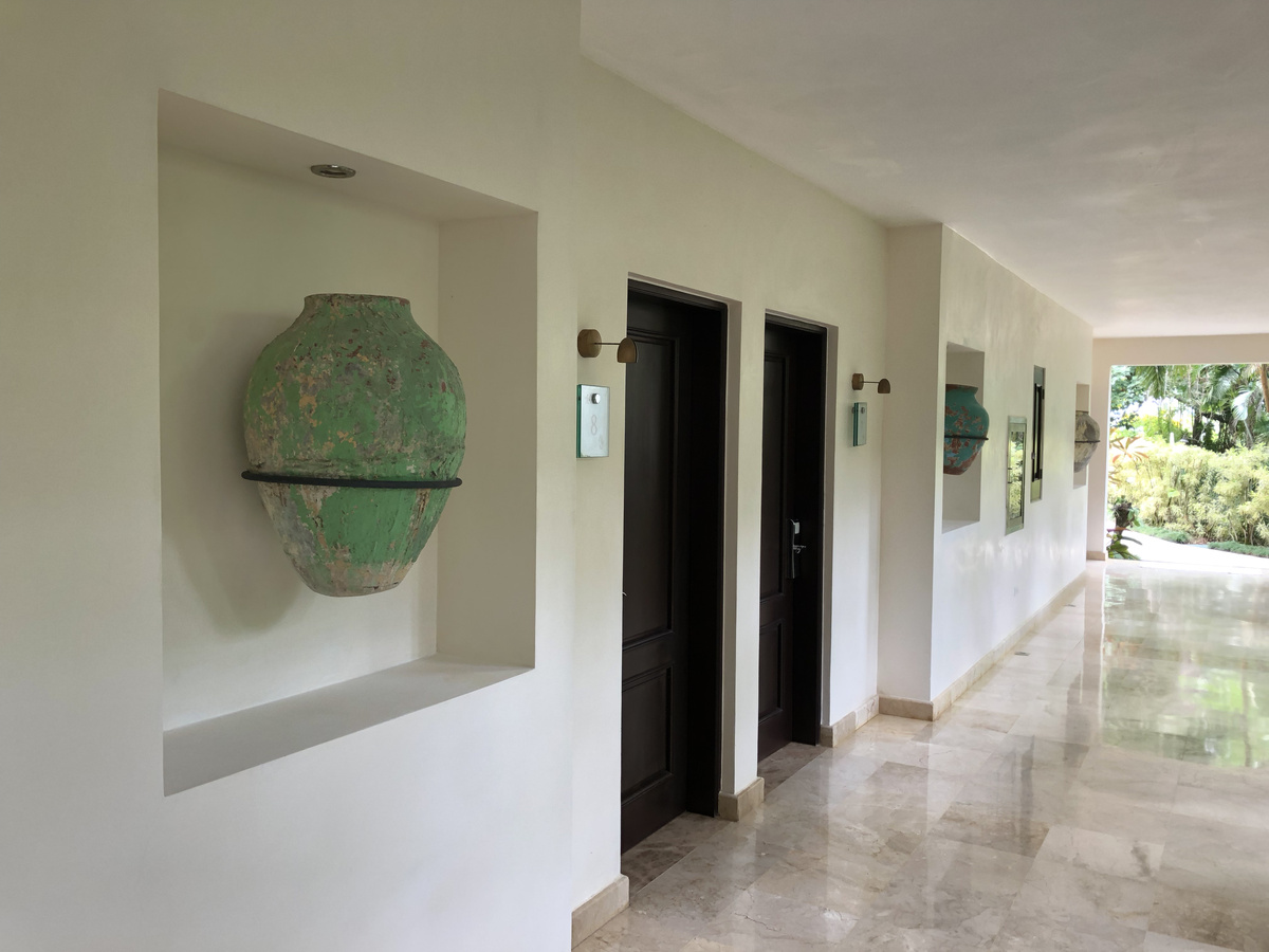 Ceramic vessels set into niches along a guest-room corridor