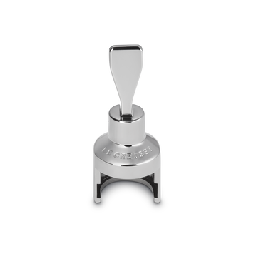 Front view of the silver Le Creuset champagne stopper with its lever upright.