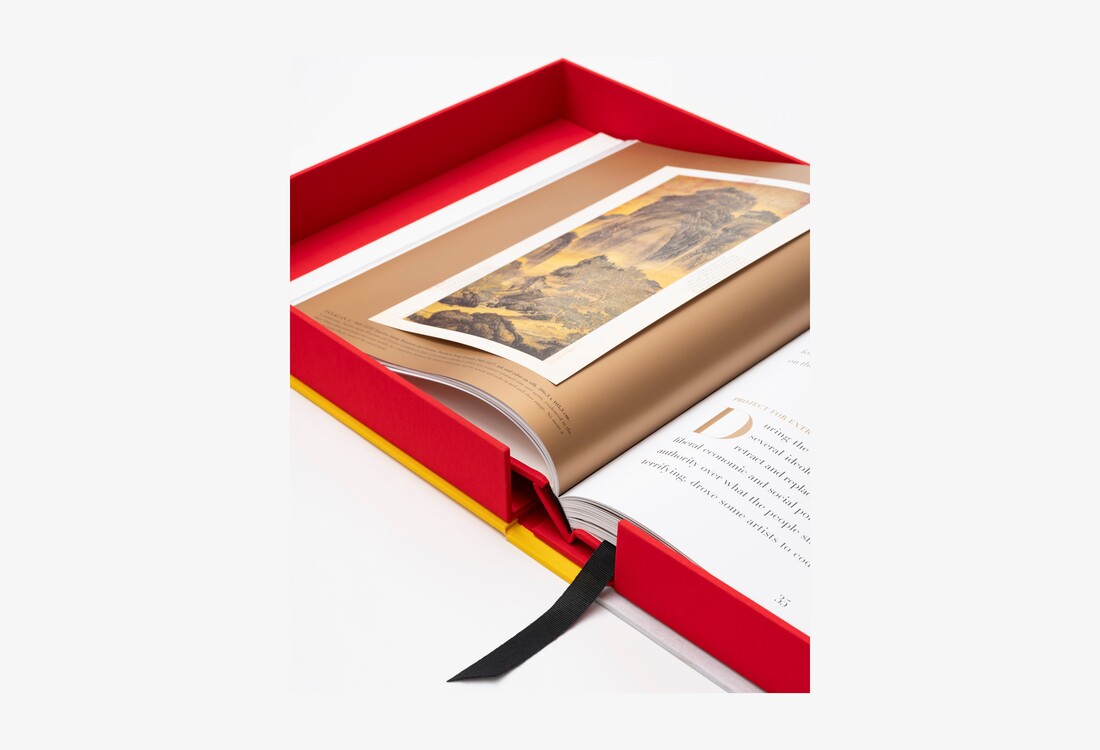 A close view of the open Chinese Art volume inside its red clamshell case, with a tipped-in artwork and ribbon bookmark.