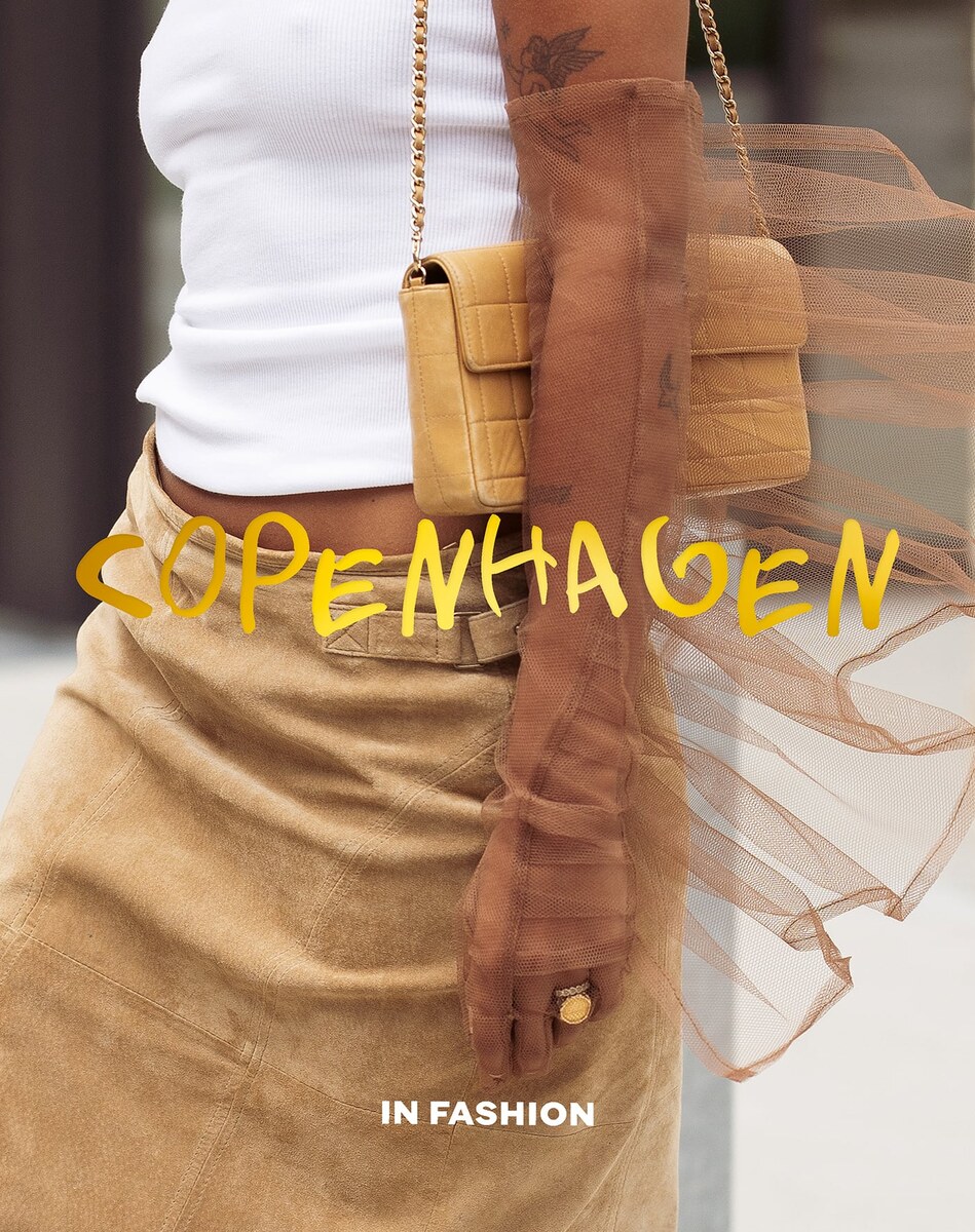 The Copenhagen In Fashion cover, showing a woman in a white top and suede skirt with a quilted bag and sheer tulle sleeve, beneath gold hand-lettering.