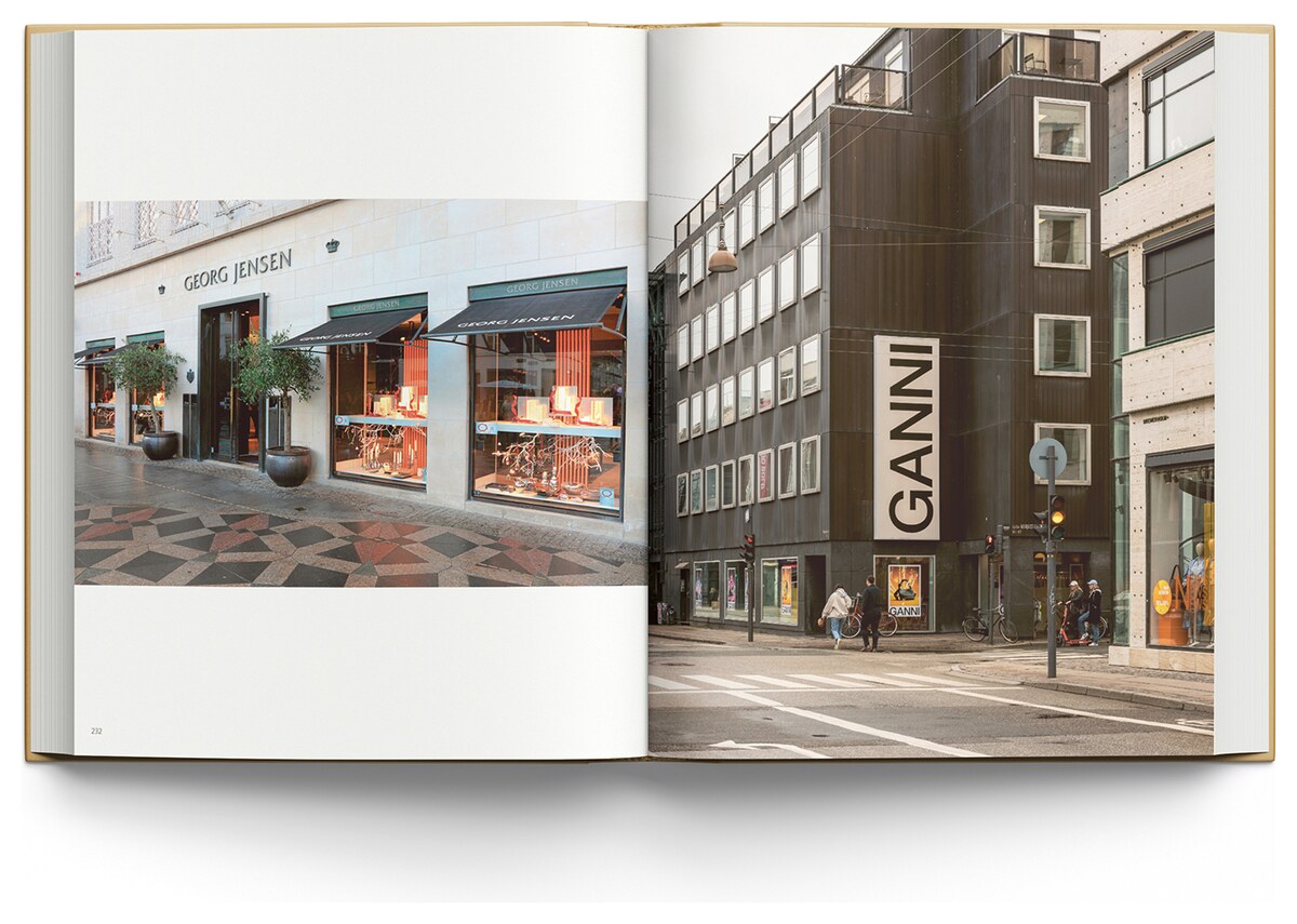 An open spread showing the Georg Jensen shopfront on a patterned pavement and the dark GANNI building on a Copenhagen street corner.