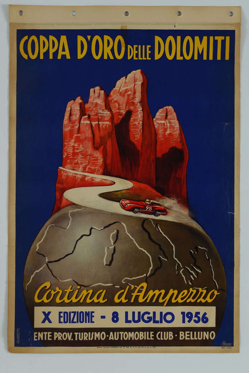 A 1956 Coppa d’Oro delle Dolomiti racing poster, with a red car on a winding road and the orange Tre Cime rising above a globe against a deep-blue background.